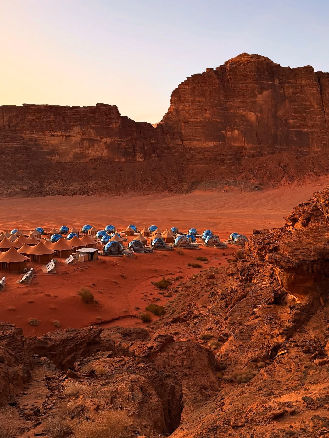 Bedouin camp in Wadi Rum desert at sunset with traditional tents