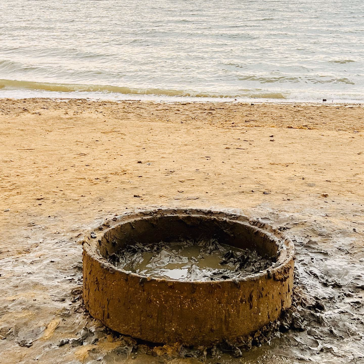 Person floating effortlessly in the Dead Sea with mountains in the background